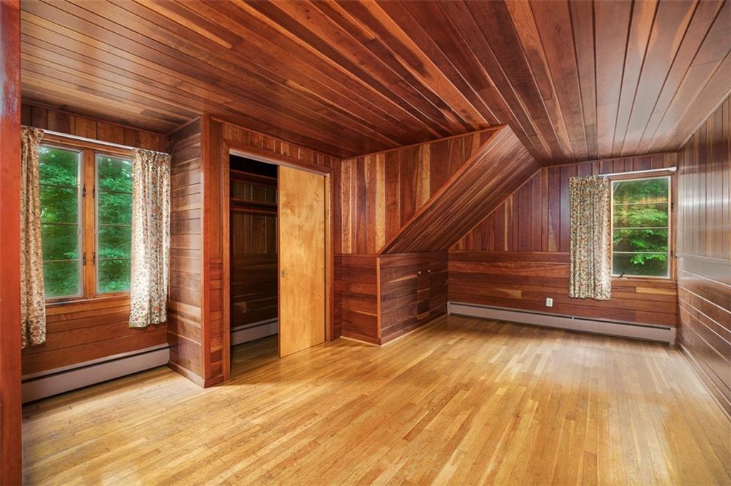 5572 Sandy Lake Polk Road Sandy Lake, PA 16145 - Photo 12 of 36 a view of an empty room with wooden floor and a window