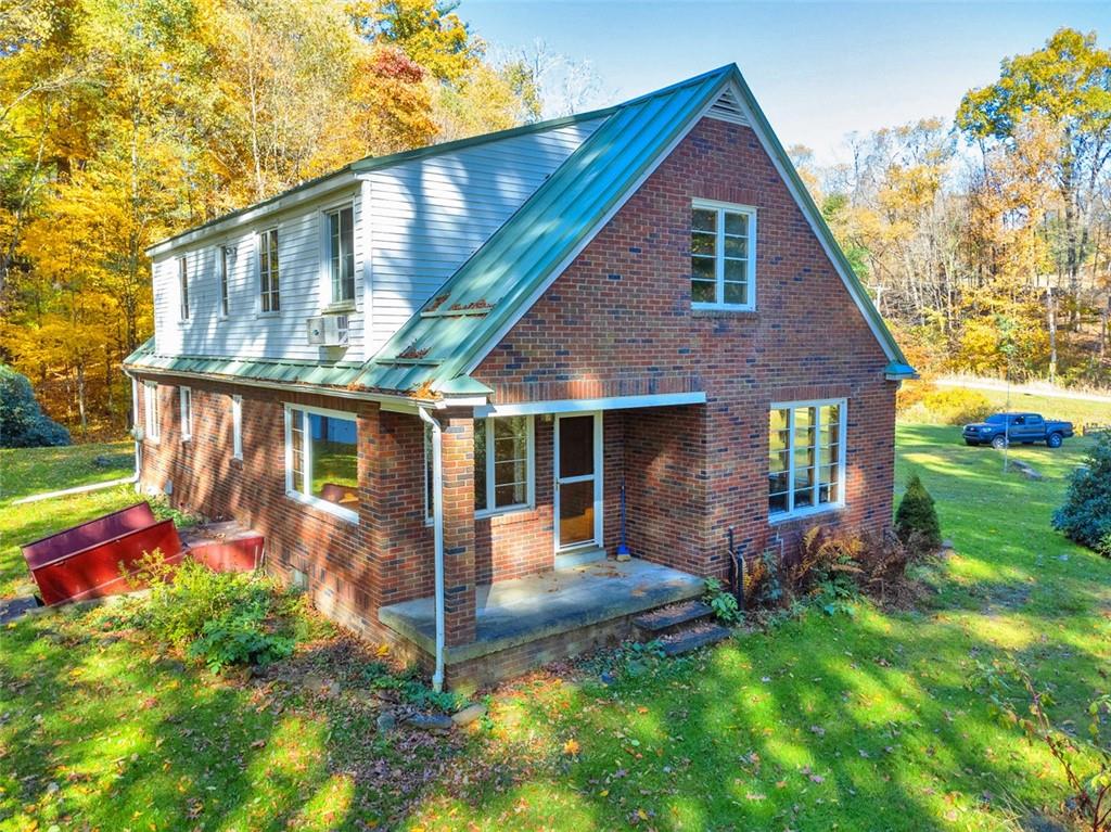 5572 Sandy Lake Polk Road Sandy Lake, PA 16145 - Photo 15 of 36 a view of a house with backyard porch and garden