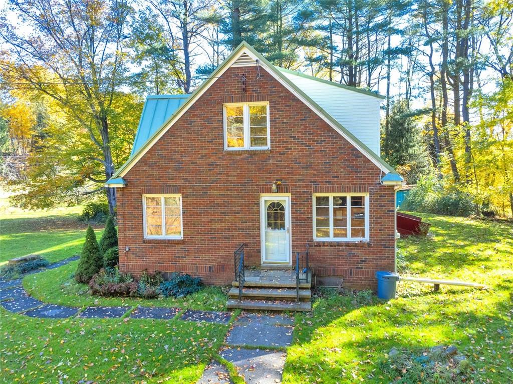 5572 Sandy Lake Polk Road Sandy Lake, PA 16145 - Photo 16 of 36 a front view of a house with a yard