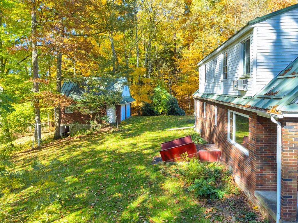 5572 Sandy Lake Polk Road Sandy Lake, PA 16145 - Photo 17 of 36 a backyard of a house with yard and outdoor seating