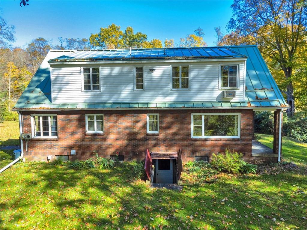 5572 Sandy Lake Polk Road Sandy Lake, PA 16145 - Photo 18 of 36 a front view of a house with garden