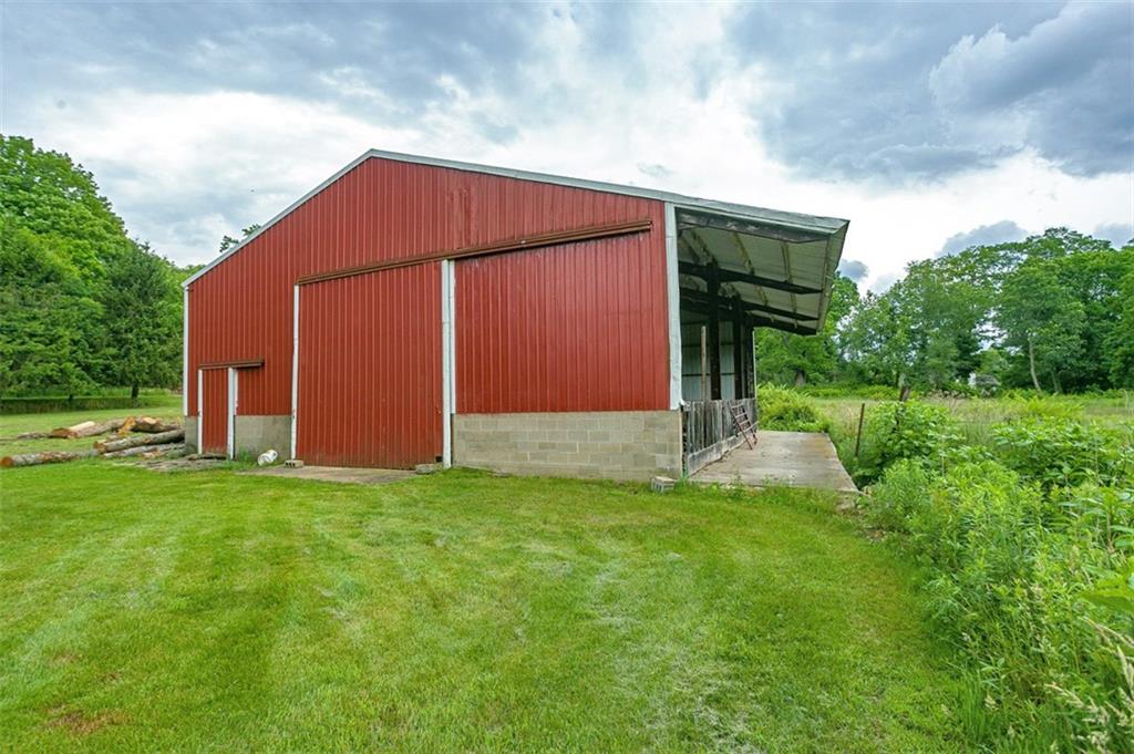5572 Sandy Lake Polk Road Sandy Lake, PA 16145 - Photo 22 of 36 a view of a backyard with potted plants and large tree