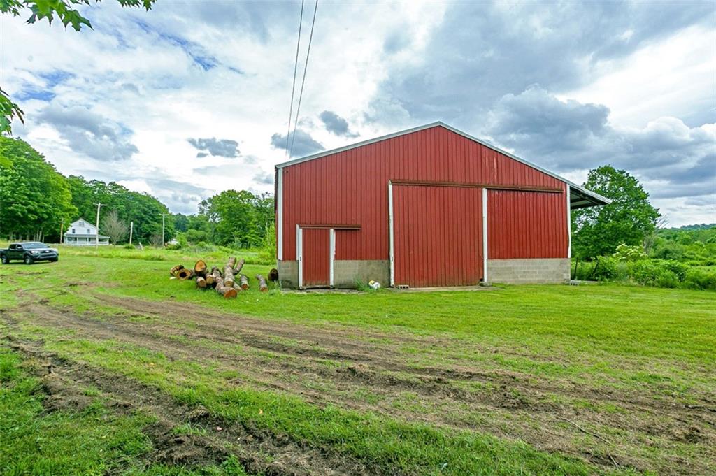 5572 Sandy Lake Polk Road Sandy Lake, PA 16145 - Photo 23 of 36 a view of a backyard with potted plants and large trees