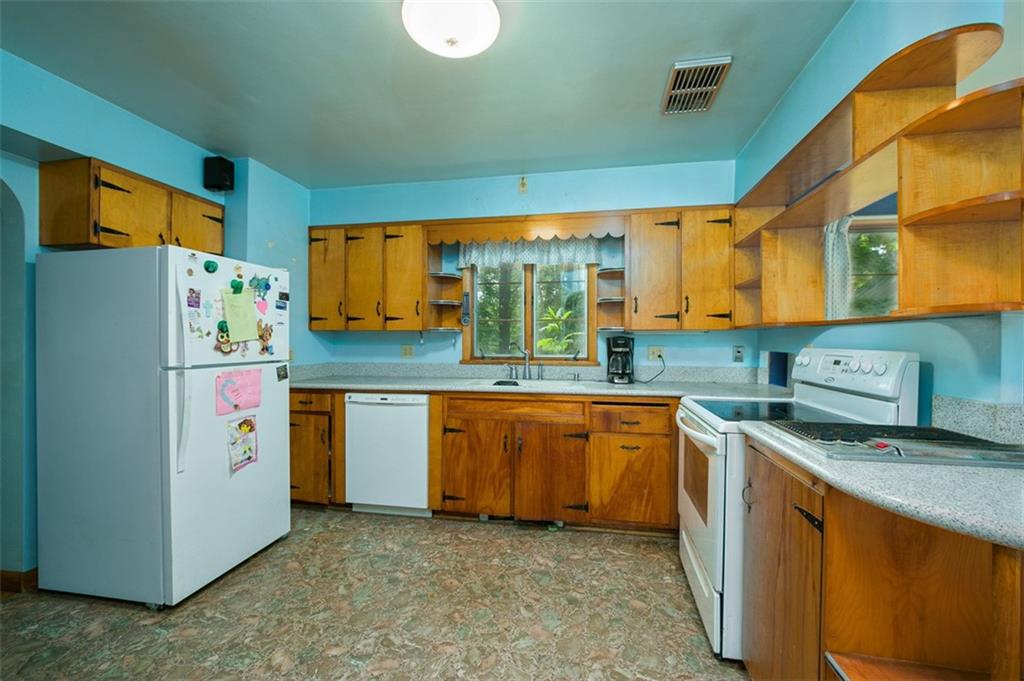 5572 Sandy Lake Polk Road Sandy Lake, PA 16145 - Photo 8 of 36 a kitchen with stainless steel appliances granite countertop a refrigerator a sink a stove and a refrigerator