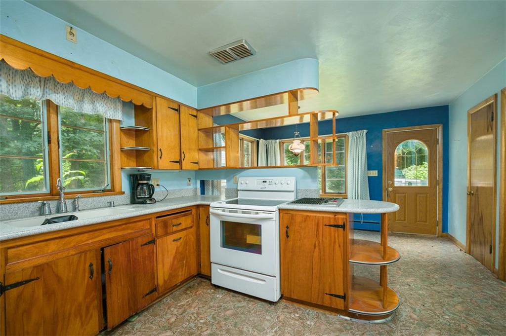 5572 Sandy Lake Polk Road Sandy Lake, PA 16145 - Photo 9 of 36 a kitchen that has a sink and a stove