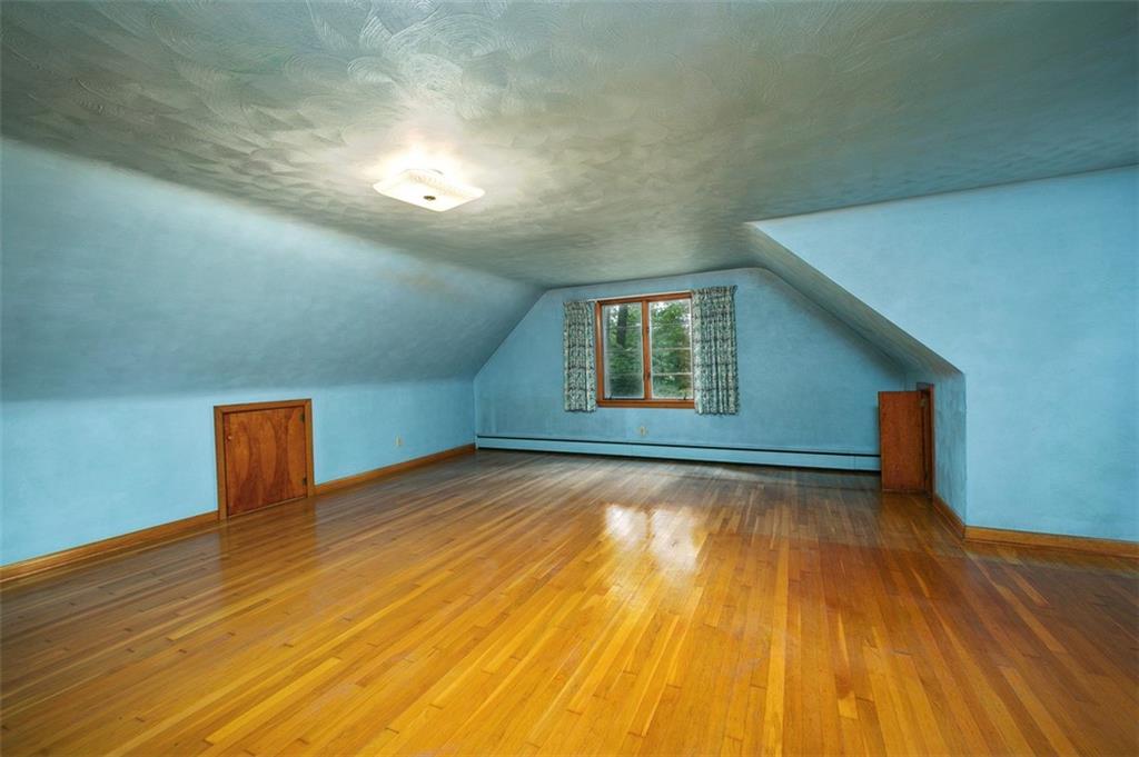 5572 Sandy Lake Polk Road Sandy Lake, PA 16145 - Photo 10 of 36 a view of an empty room with wooden floor and a window