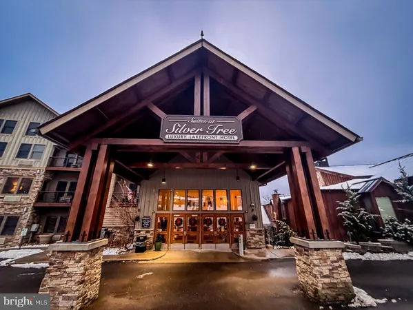 a view of a patio with table and chairs with wooden floor and plants