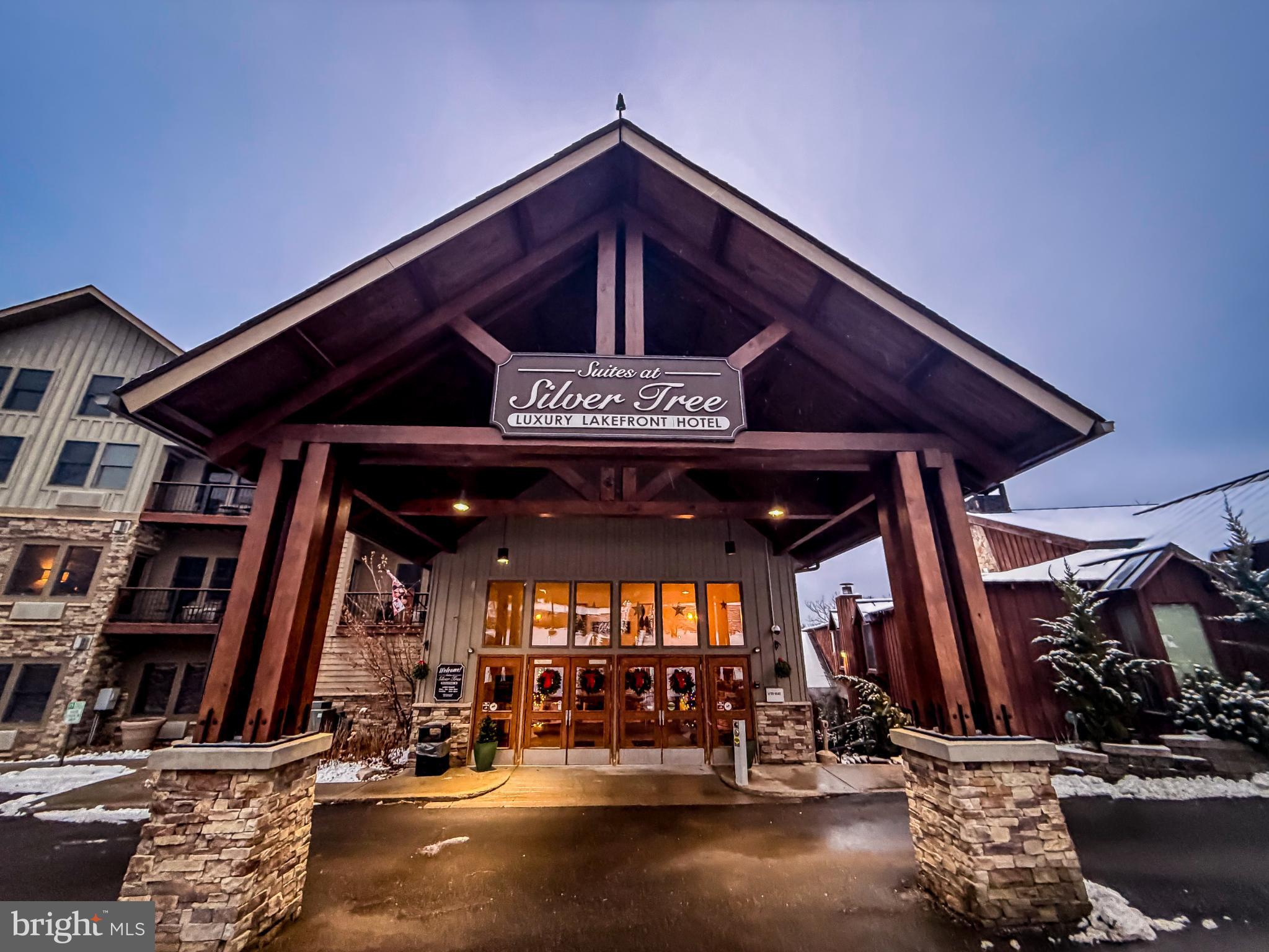 a view of a patio with table and chairs with wooden floor and plants