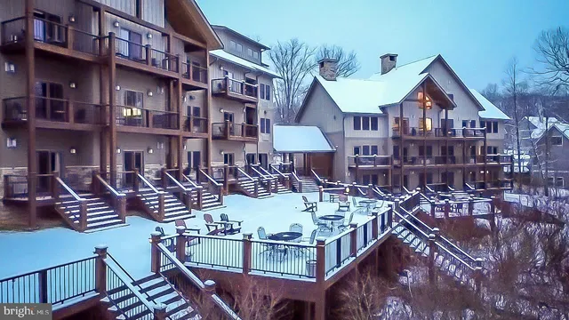 a front view of a house with balcony and outdoor seating