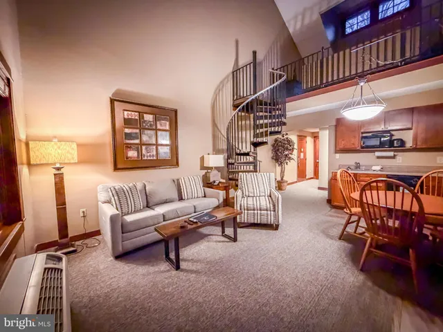 a living room with furniture gym equipment and a table