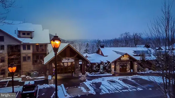 a aerial view of a house with swimming pool and furniture