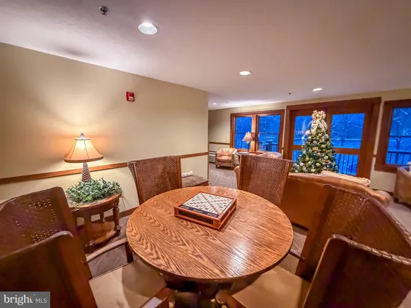 a living room with furniture a lamp and a dining table