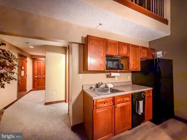 a kitchen that has a sink a refrigerator and a stove