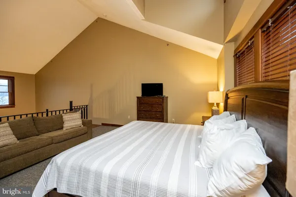 a bedroom with a bed and a couch