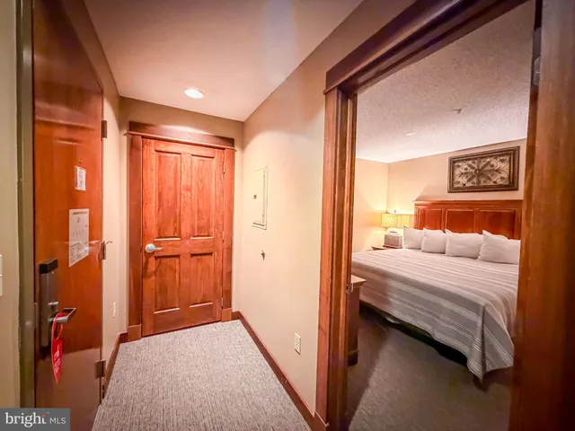 a bedroom with a bed and a cabinet