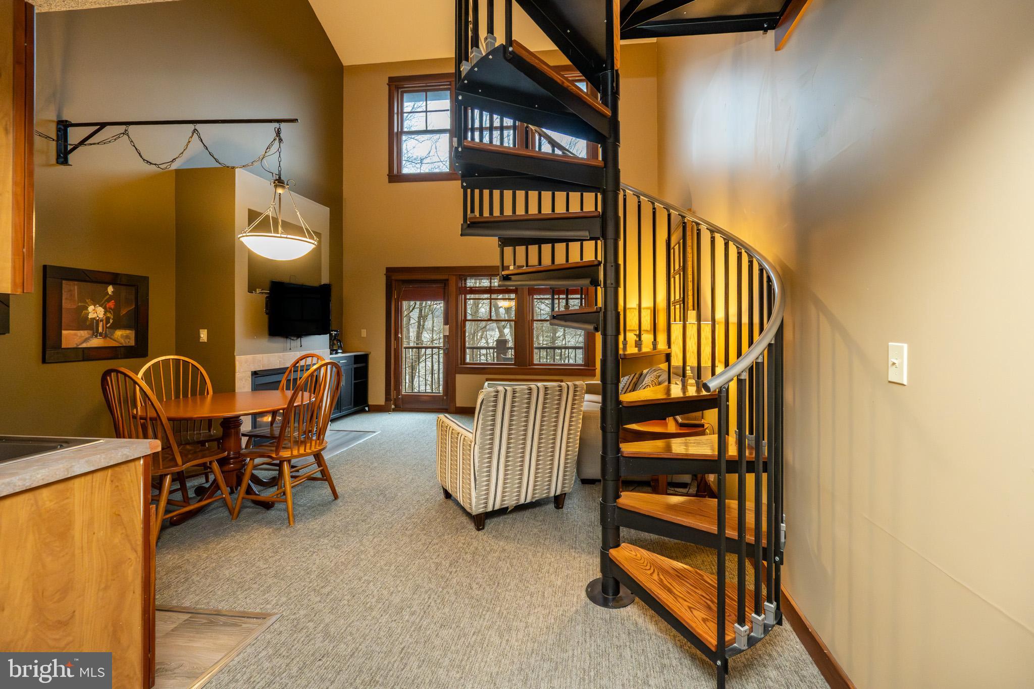 565 Glendale Road, Unit B206 Oakland, MD 21550 - Photo 9 of 32 Charming spiral staircase in cozy living space.
