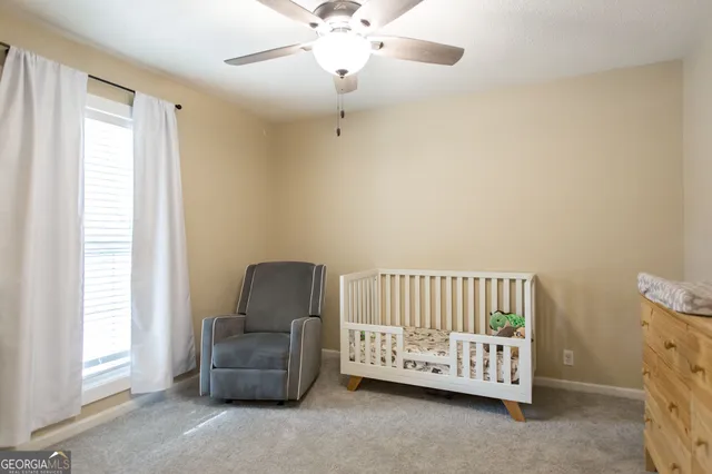 a bedroom with a bed and a couch