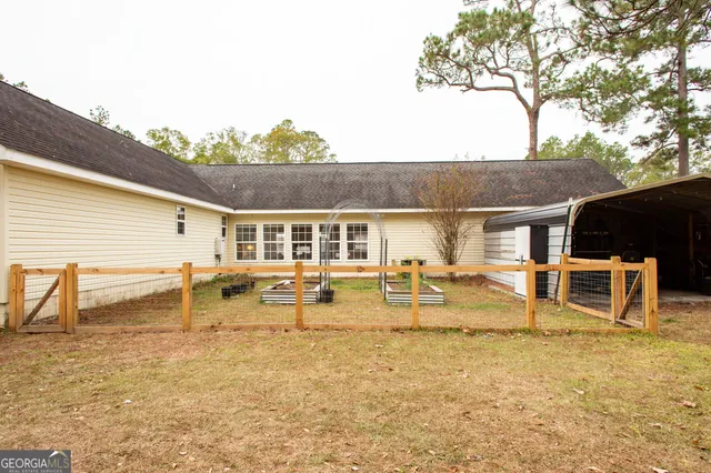 a view of a house with backyard and sitting area