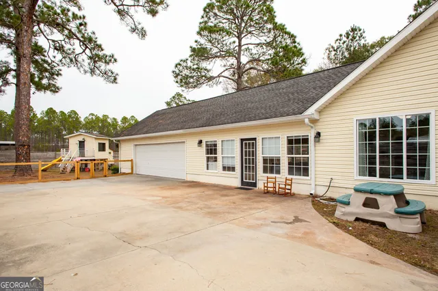a backyard of a house with yard and outdoor seating