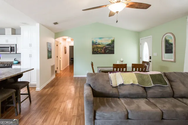 a living room with furniture and wooden floor