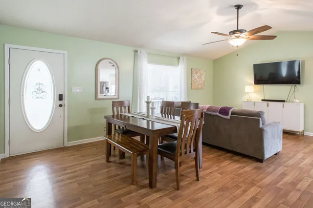 a view of a dining room with furniture and wooden floor