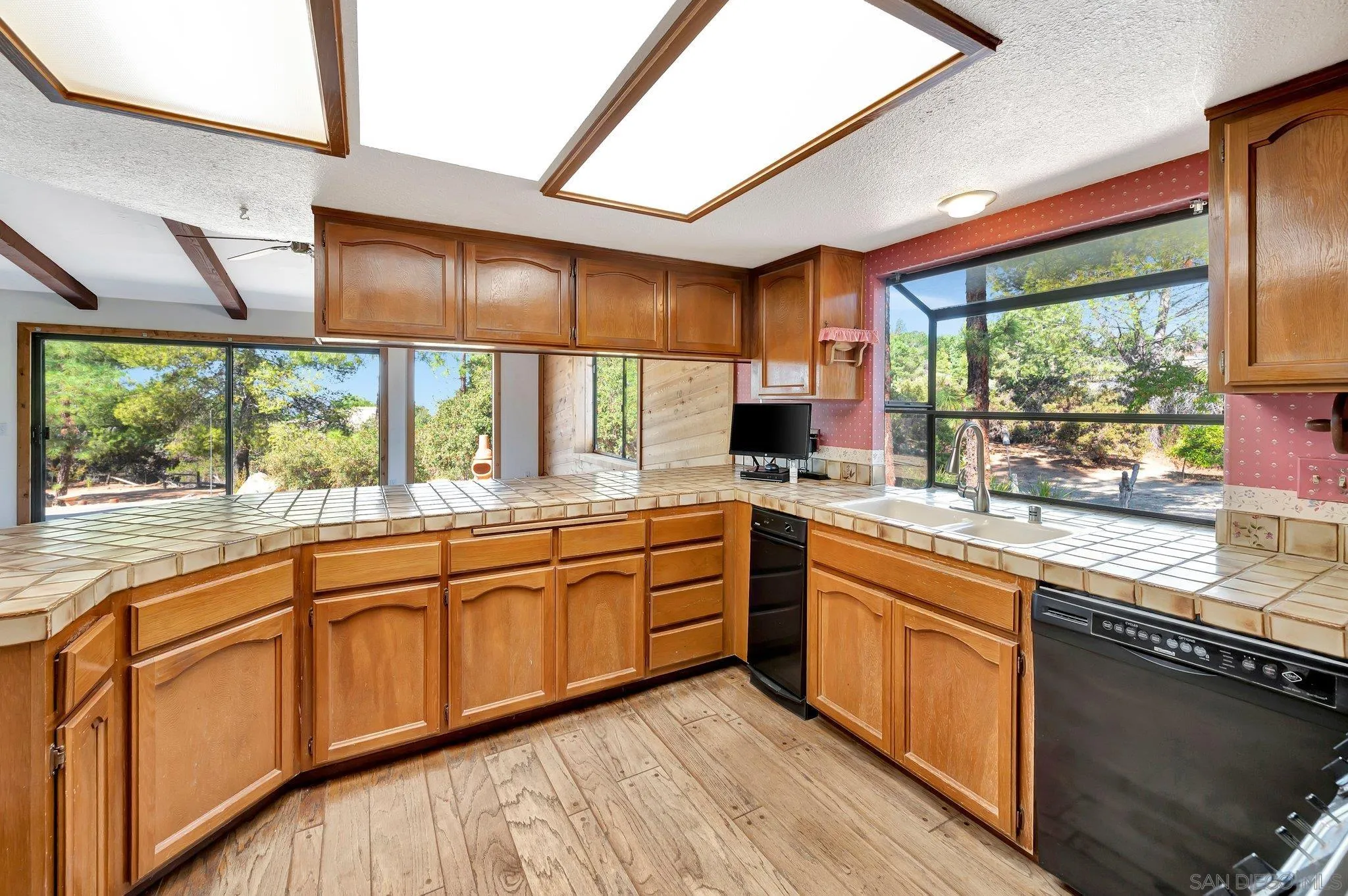 2596 Valetta Lane Alpine, CA 91901 - Photo 14 of 48 a kitchen with stainless steel appliances granite countertop sink stove and large window