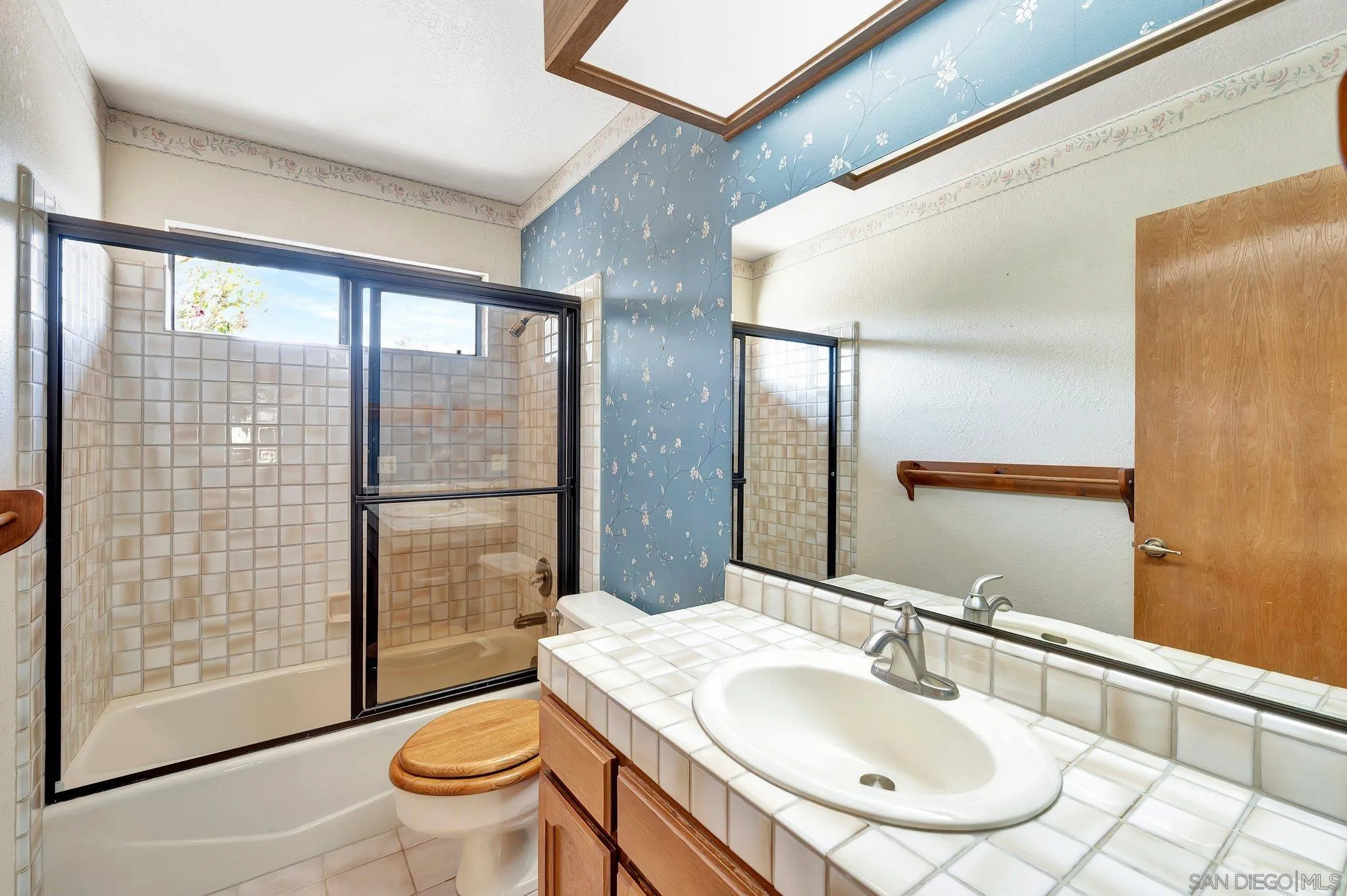 2596 Valetta Lane Alpine, CA 91901 - Photo 24 of 48 a bathroom with a granite countertop sink a toilet a mirror and shower
