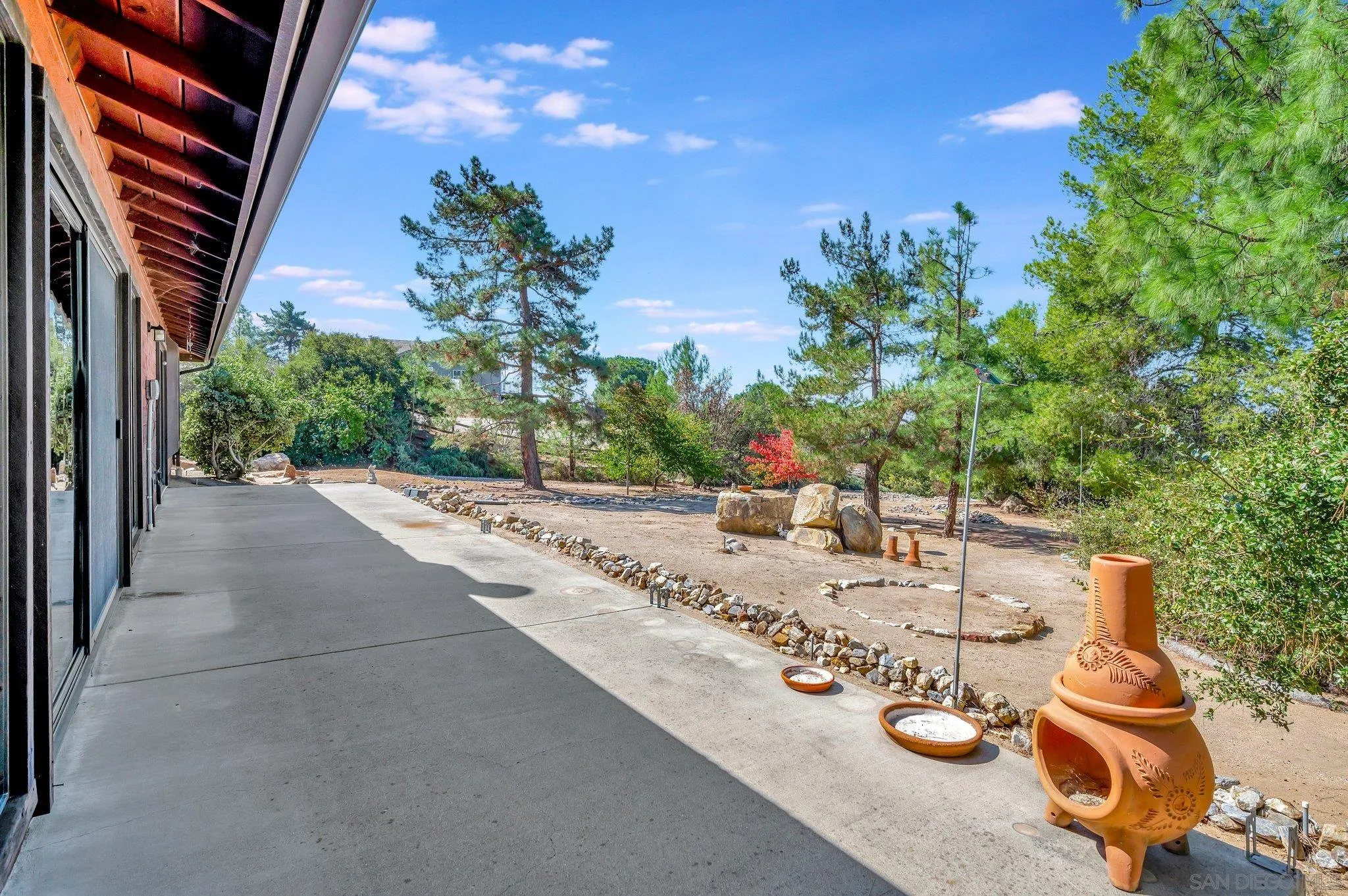 2596 Valetta Lane Alpine, CA 91901 - Photo 30 of 48 a view of a house with backyard sitting area and garden