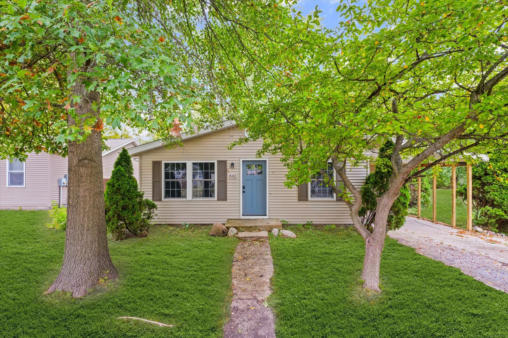 a front view of house with yard and green space