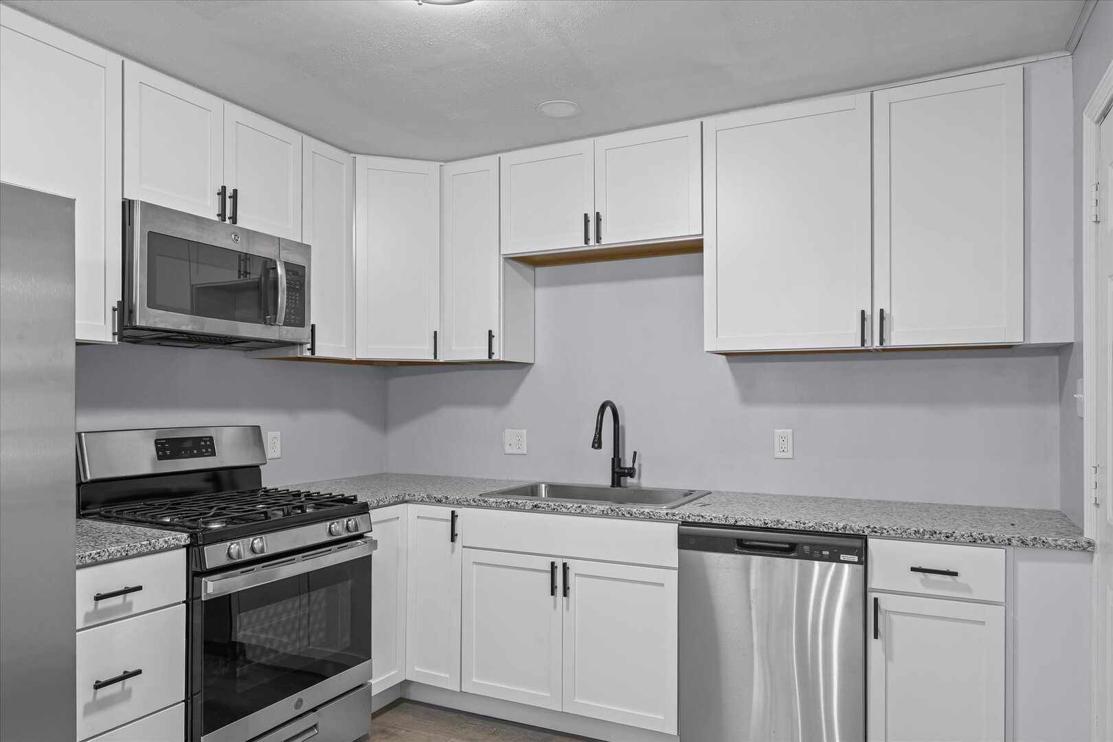 842 North Walnut Street Monticello, IL 61856 - Photo 11 of 33 a kitchen with stainless steel appliances granite countertop white cabinets a sink and dishwasher