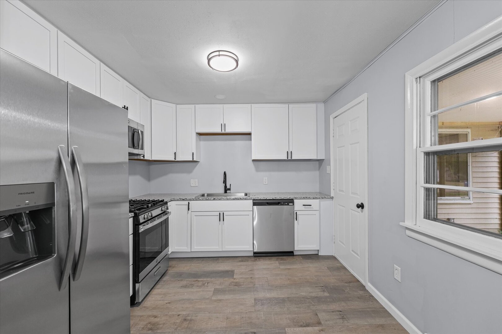 842 North Walnut Street Monticello, IL 61856 - Photo 12 of 33 a kitchen with stainless steel appliances granite countertop a stove a sink and a refrigerator