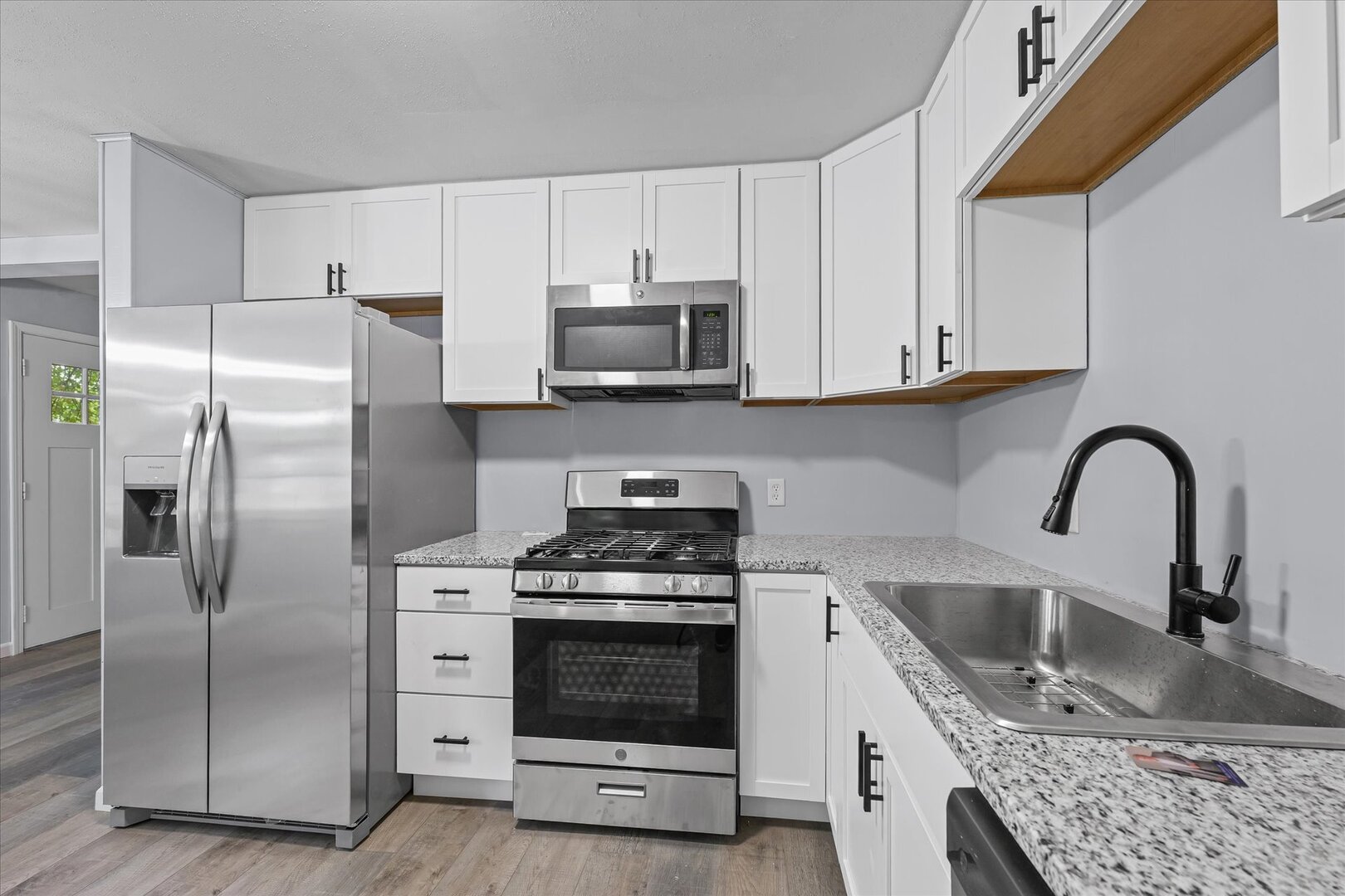 842 North Walnut Street Monticello, IL 61856 - Photo 13 of 33 a kitchen with stainless steel appliances granite countertop a stove a refrigerator and a sink