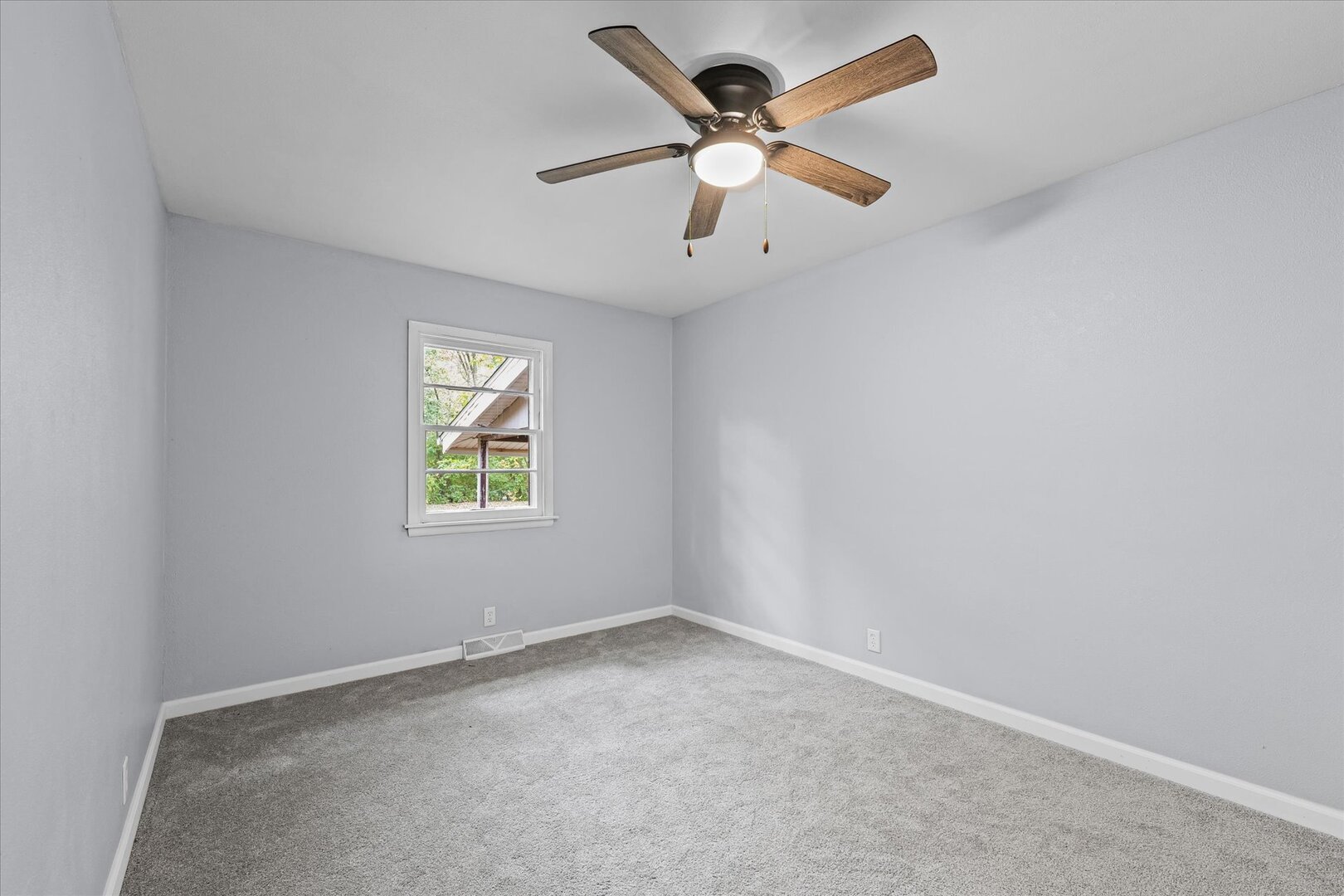 842 North Walnut Street Monticello, IL 61856 - Photo 17 of 33 an empty room with a window and a fan