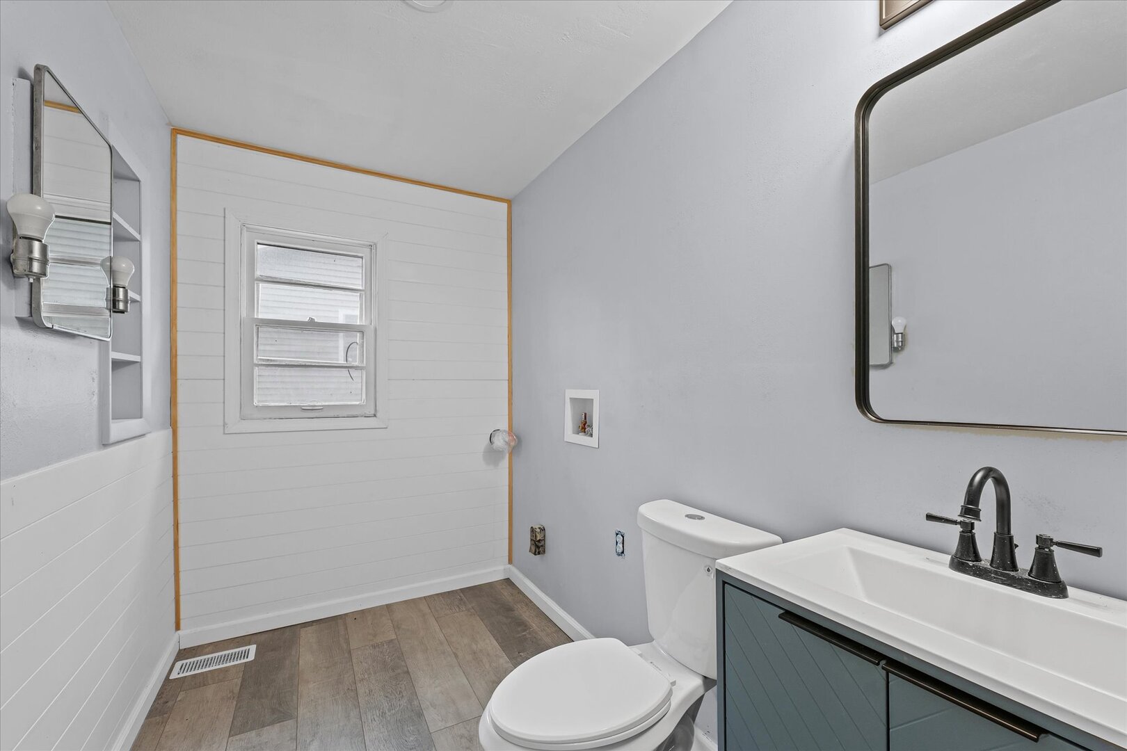 842 North Walnut Street Monticello, IL 61856 - Photo 21 of 33 a bathroom with a toilet sink and mirror