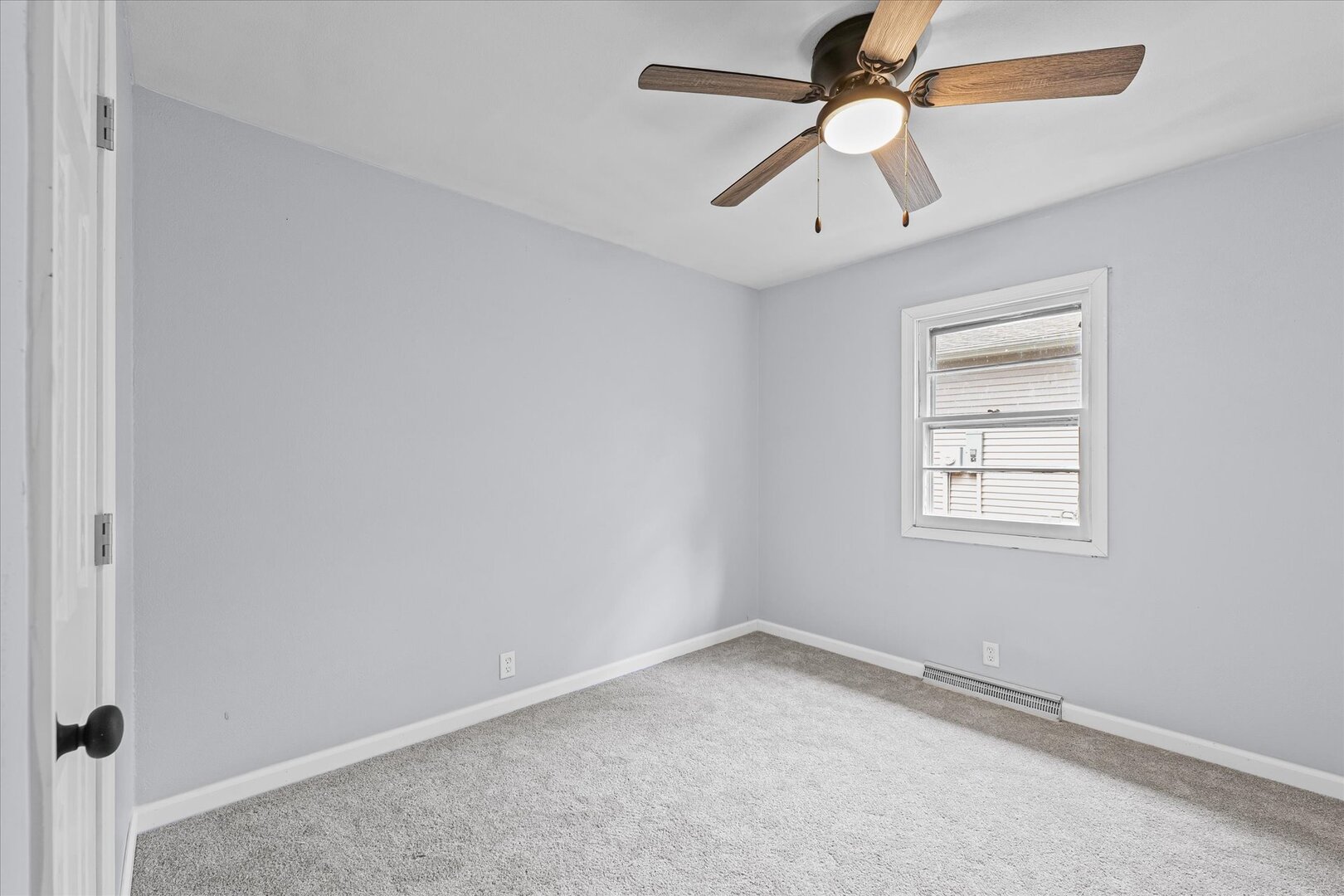 842 North Walnut Street Monticello, IL 61856 - Photo 22 of 33 an empty room with a window and a fan