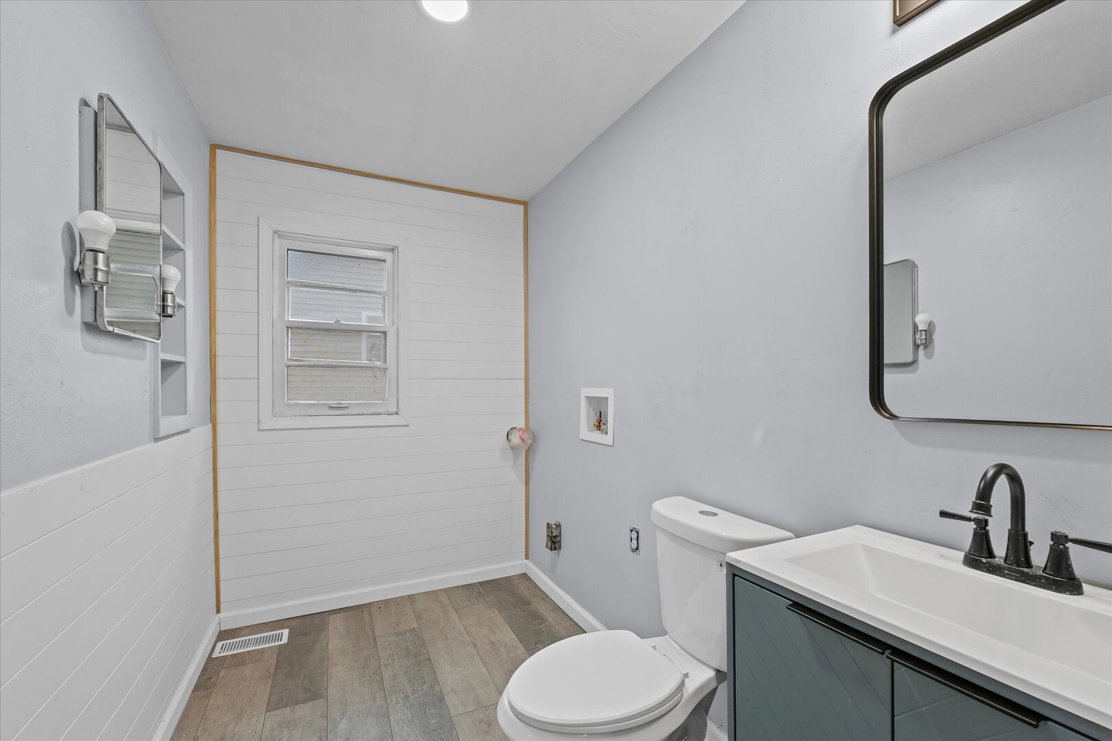 842 North Walnut Street Monticello, IL 61856 - Photo 24 of 33 a bathroom with a granite countertop toilet sink and mirror