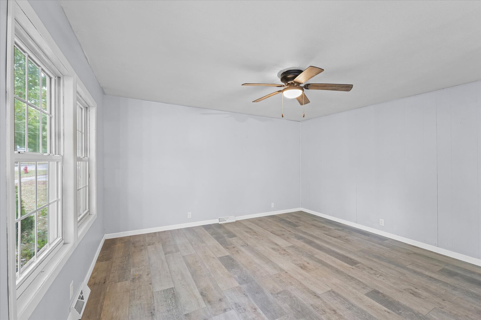 842 North Walnut Street Monticello, IL 61856 - Photo 5 of 33 wooden floor in an empty room with a window