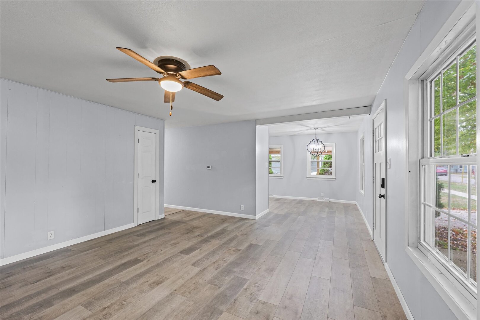 842 North Walnut Street Monticello, IL 61856 - Photo 7 of 33 a view of a livingroom with a chandelier fan and windows