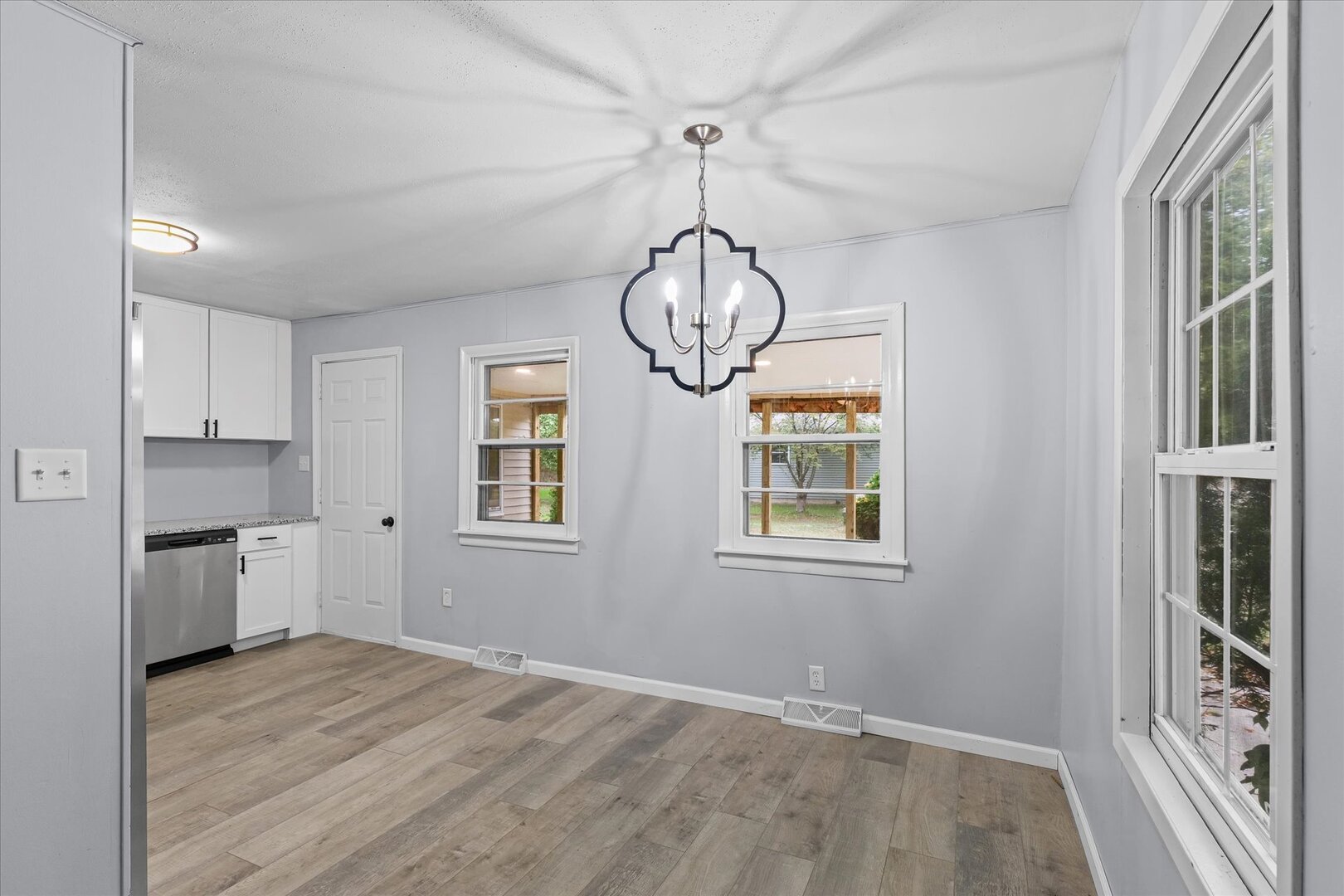 842 North Walnut Street Monticello, IL 61856 - Photo 8 of 33 a view of empty room with wooden floor and windows