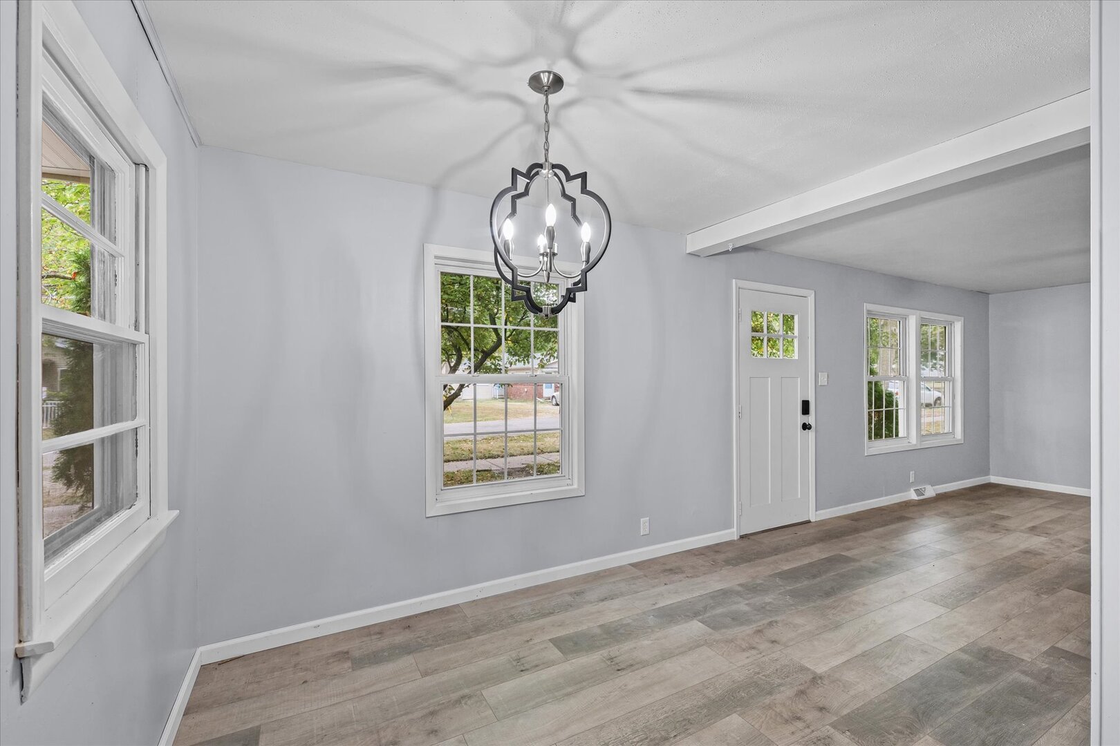 842 North Walnut Street Monticello, IL 61856 - Photo 9 of 33 an empty room with windows and chandelier