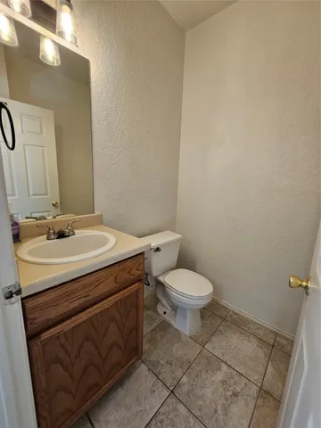a view of a kitchen with a sink and a refrigerator