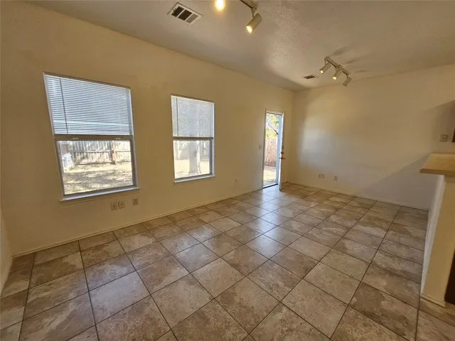 a view of a hallway with closet and a window