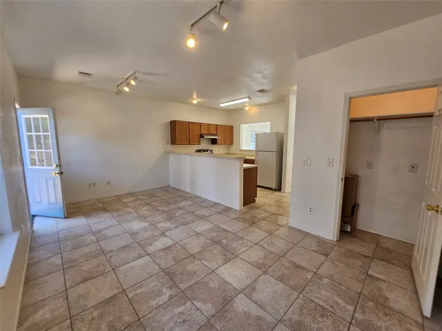 a kitchen with stainless steel appliances a refrigerator and a stove top oven