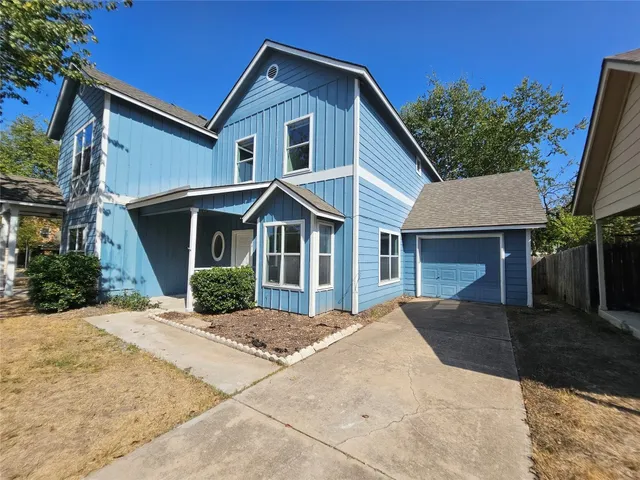 a view of empty room with window and ceiling fan