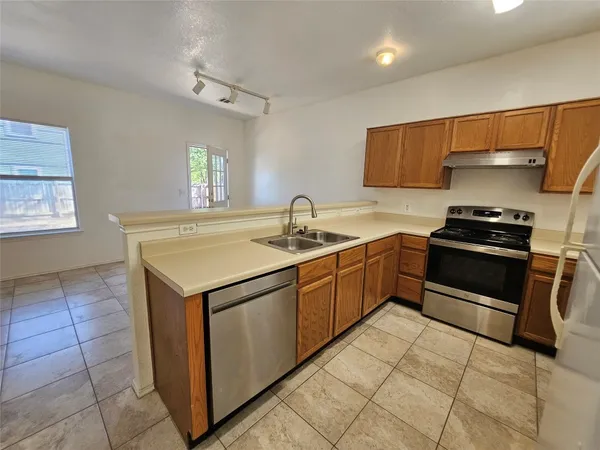 a kitchen with a sink appliances and cabinets
