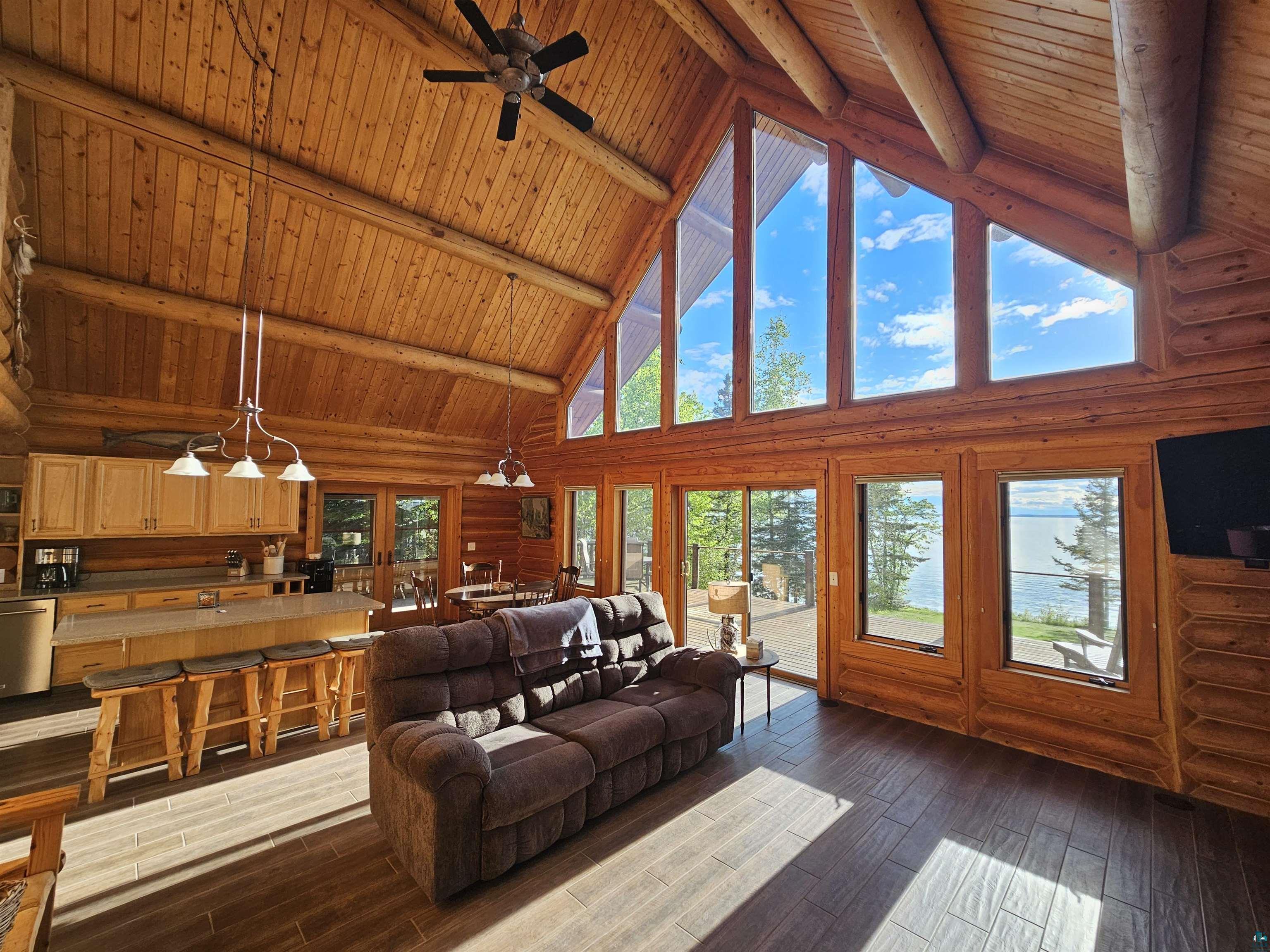 90185 Birch Hill Road Cornucopia, WI 54827 - Photo 3 of 43 Living room featuring high vaulted ceiling, wooden ceiling, plenty of natural light, and beamed ceiling