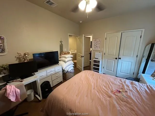a bedroom with a bed and flat screen tv