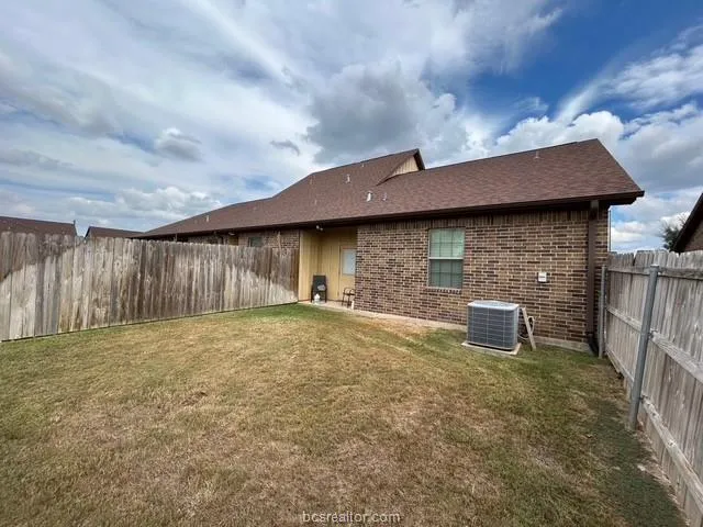 a backyard of a house with table and chairs
