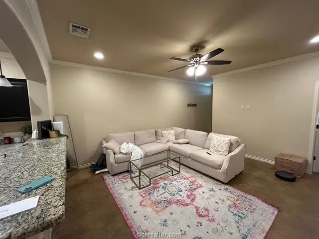 a living room with furniture and a flat screen tv