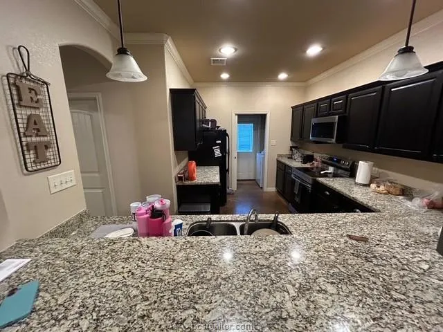 a room with gym equipment and a flat screen tv